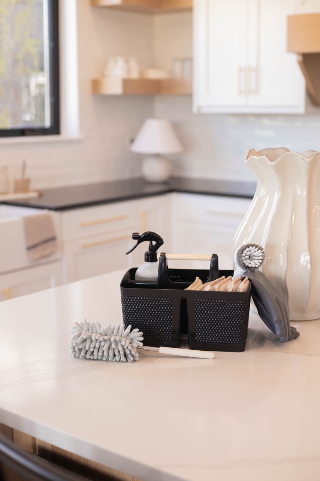 A LivFlo cleaning caddy with pro-grade tools and supplies on a kitchen counter.