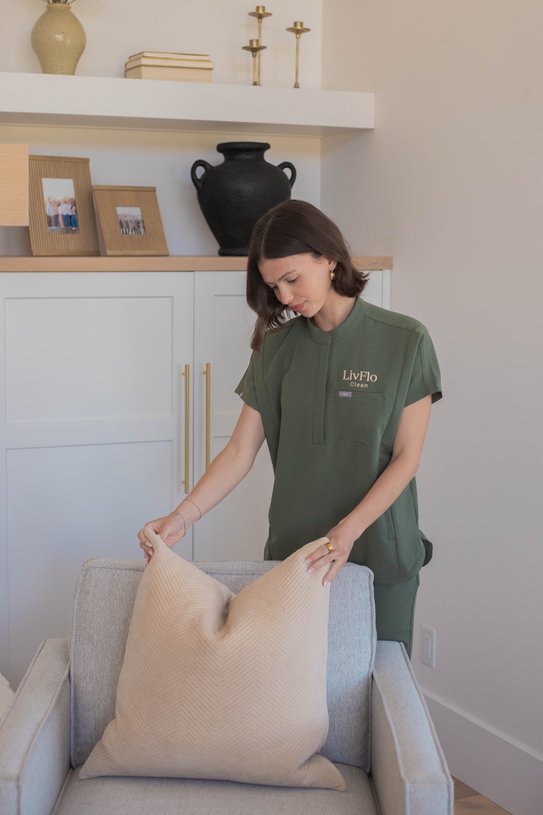 A LivFlo duo team cleaning a bright, modern living space.