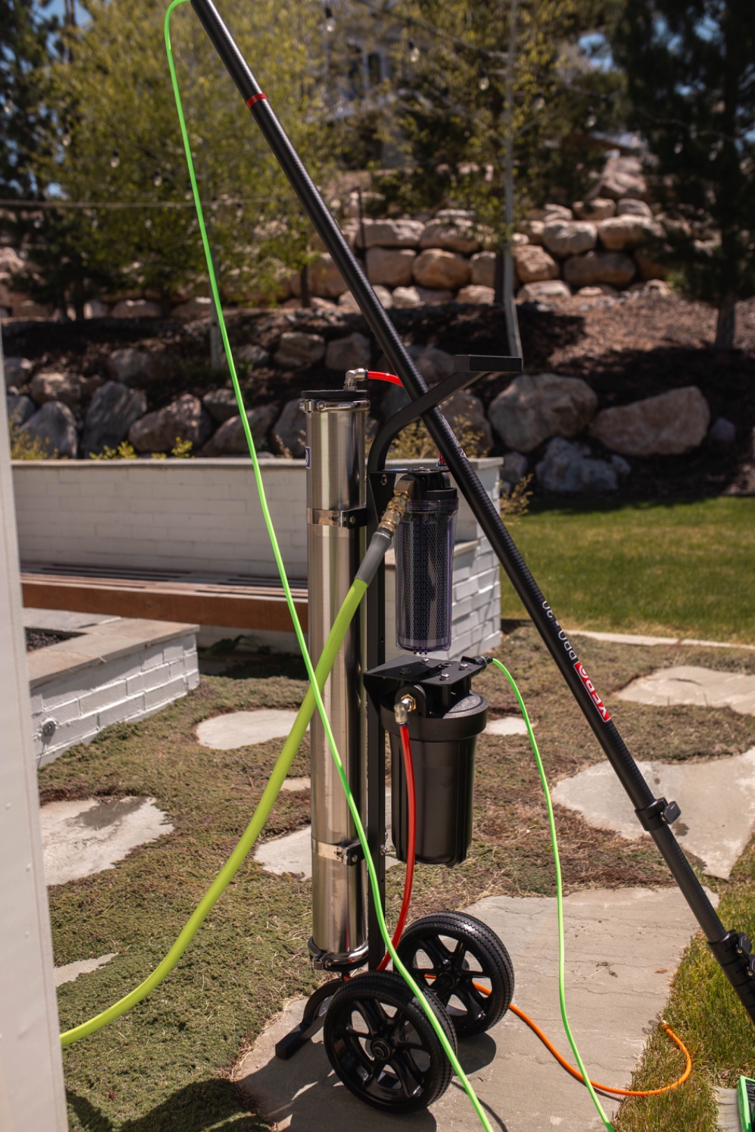 A LivFlo window-cleaning cart and water-fed pole setup on site.